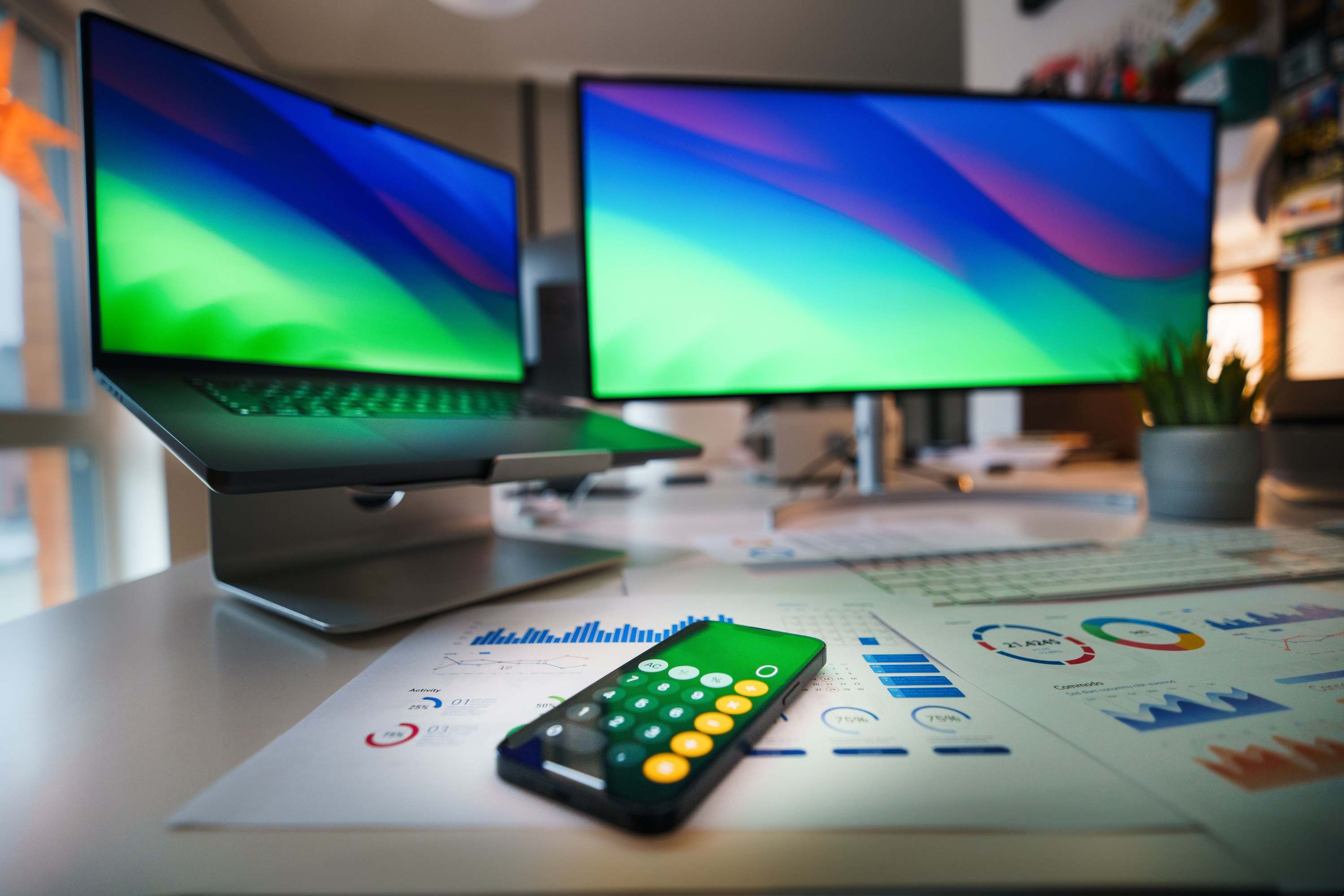 Laptop and monitors on a desk in an office workspace